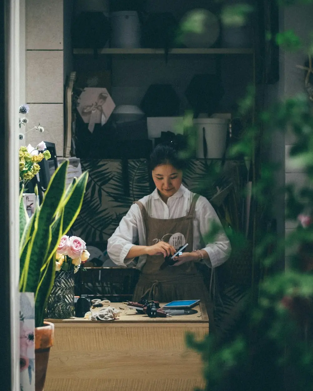 A florist arranging flowers in her shop