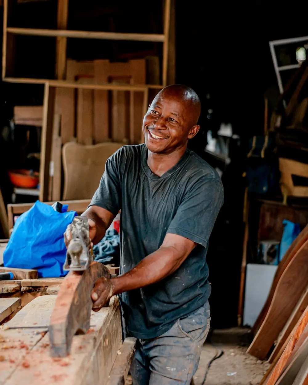 A carpenter smiling in his workshop