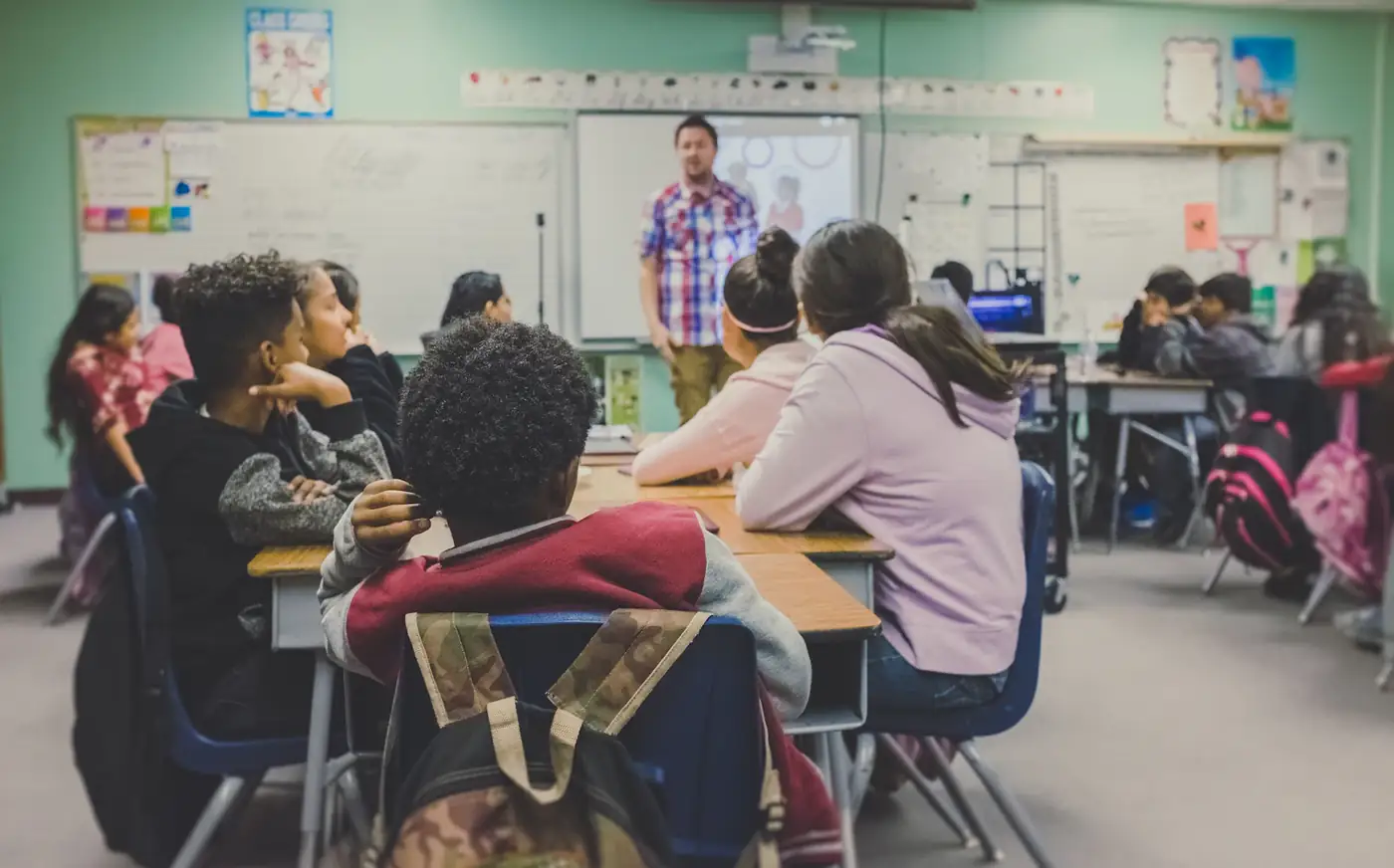 Students seen from behind listening to their teacher