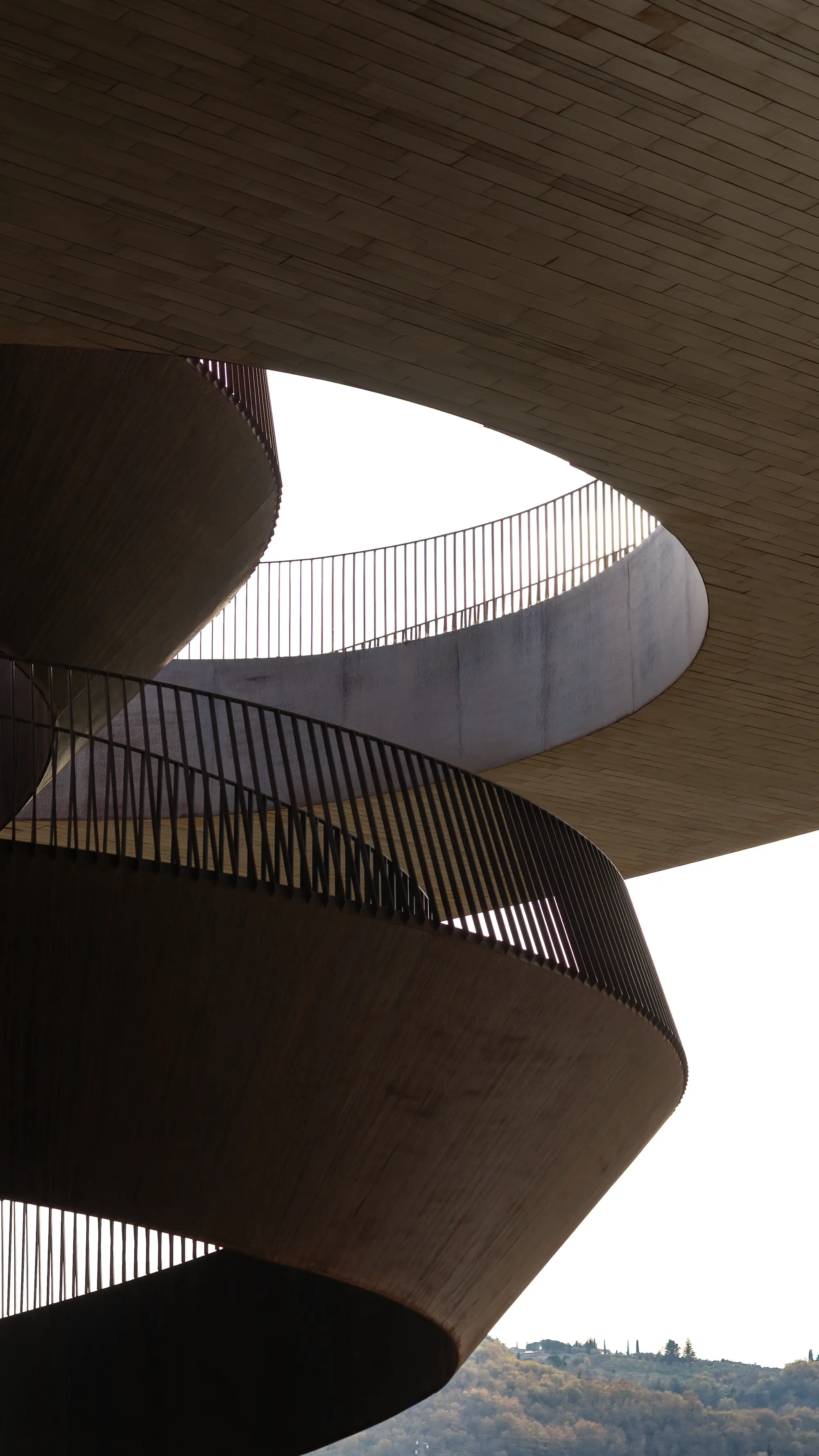 Curved concrete ramps and railings seen from below