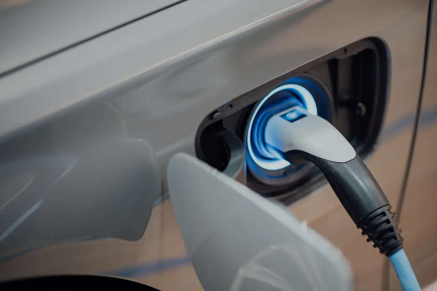Charging port glowing blue on the side of a car