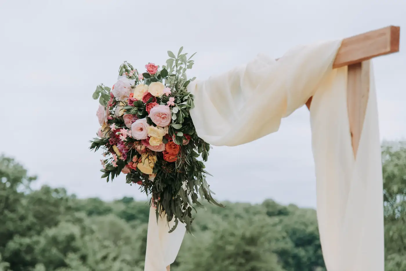 Bouquet tied to a white drape on a hill