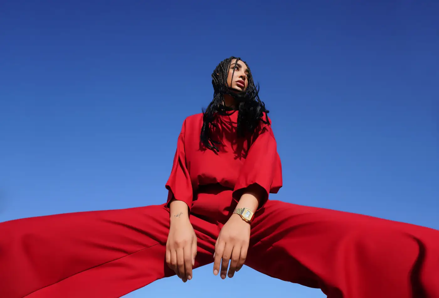 Red outfit against a blue sky