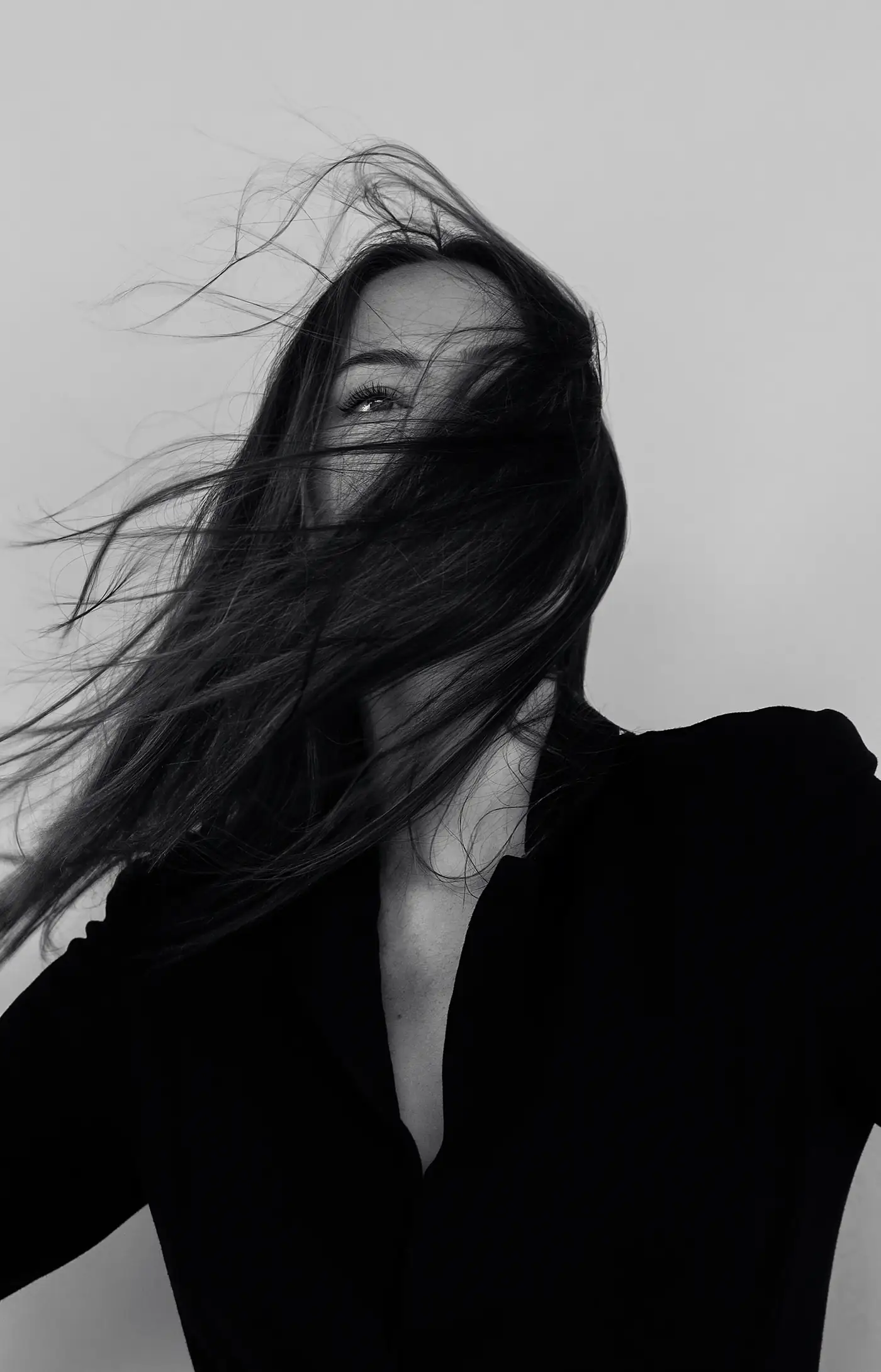 Black and white portrait with hair across the face