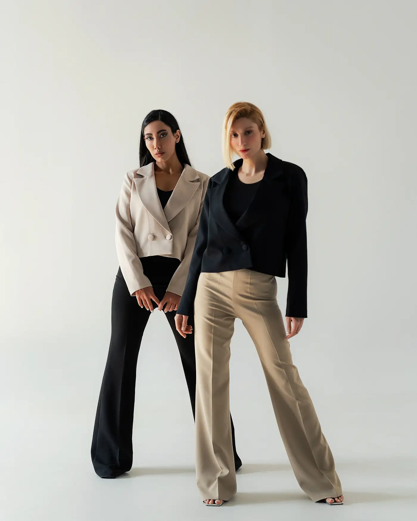 Two models in tailored jackets and wide trousers