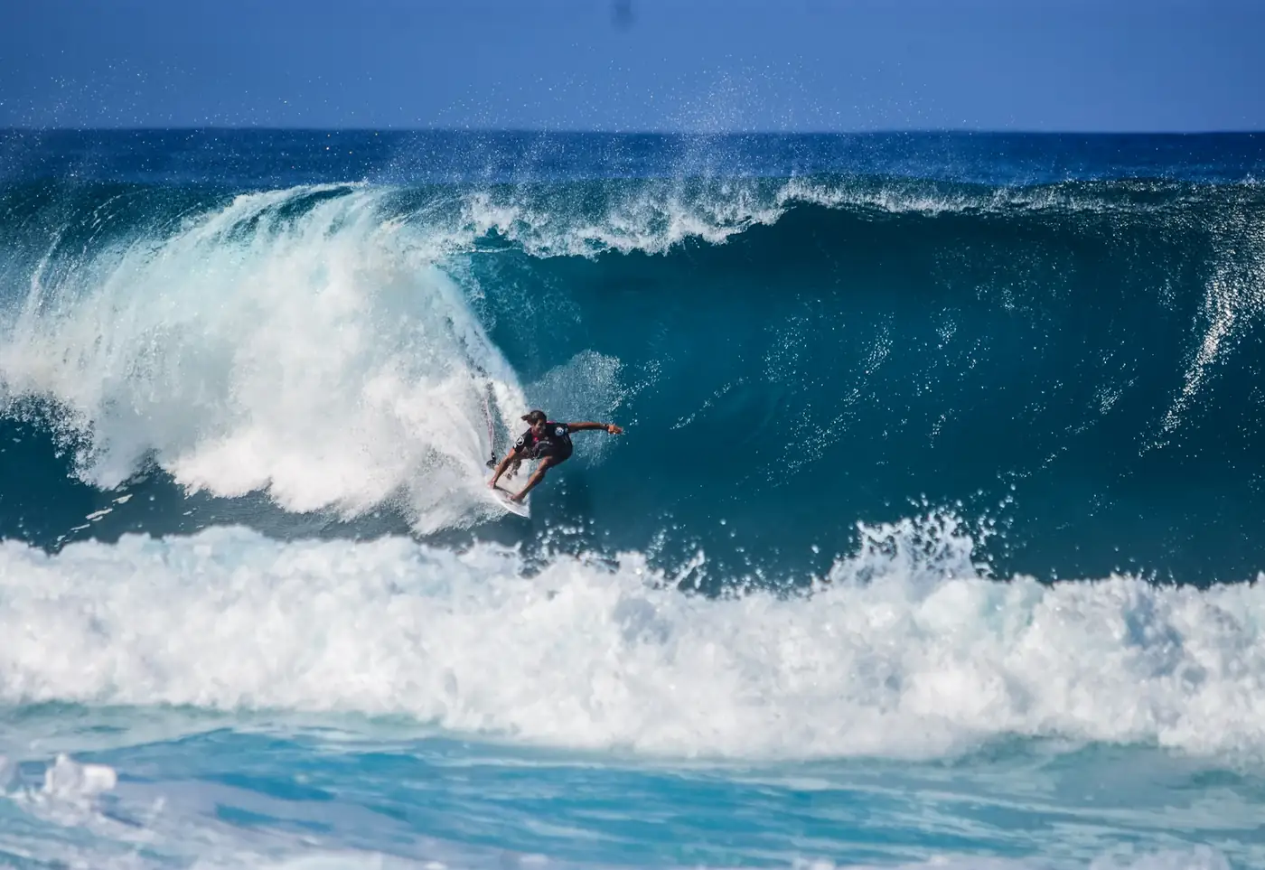 Surfer on a big wave throwing spray