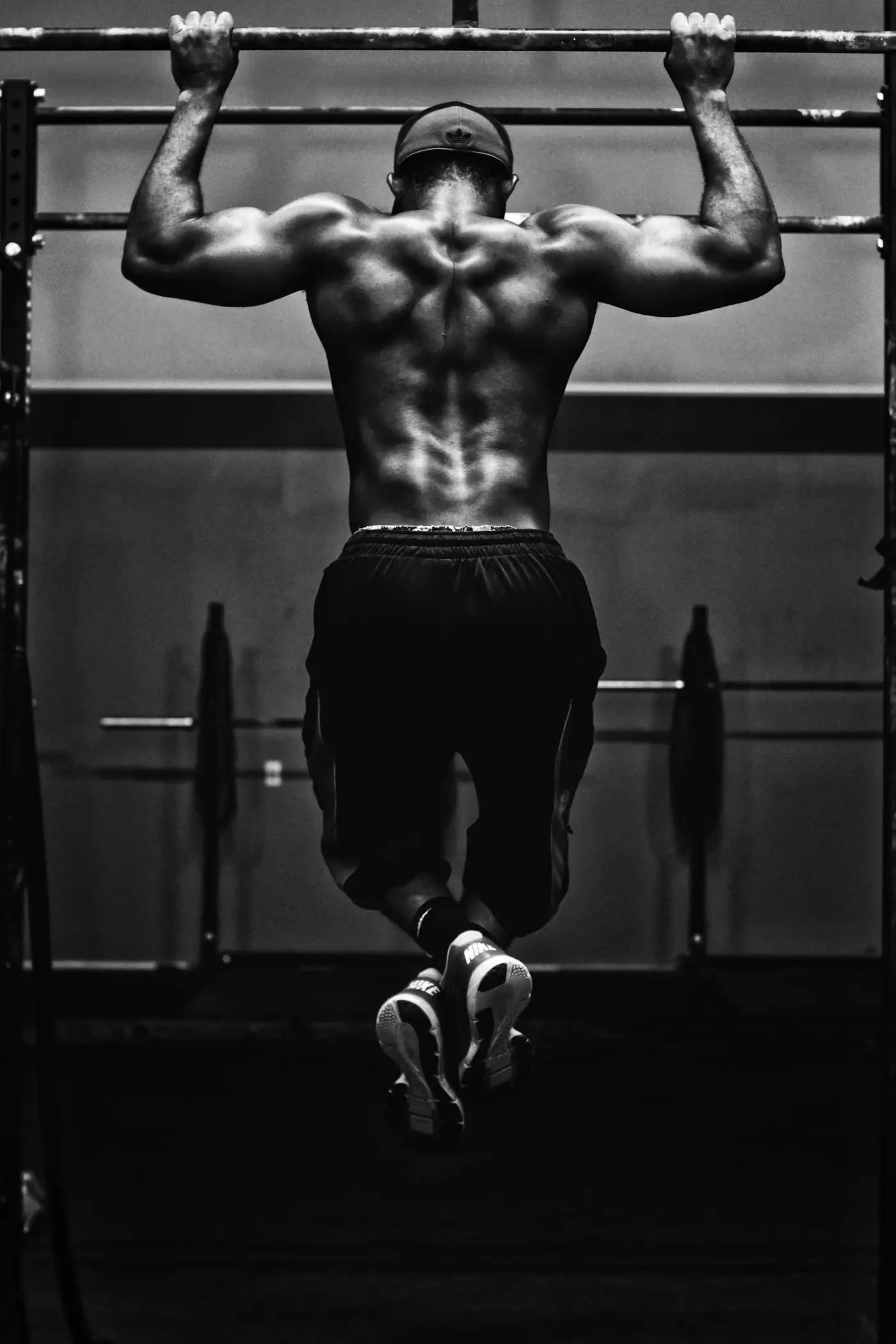 Athlete lifting a barbell in black and white