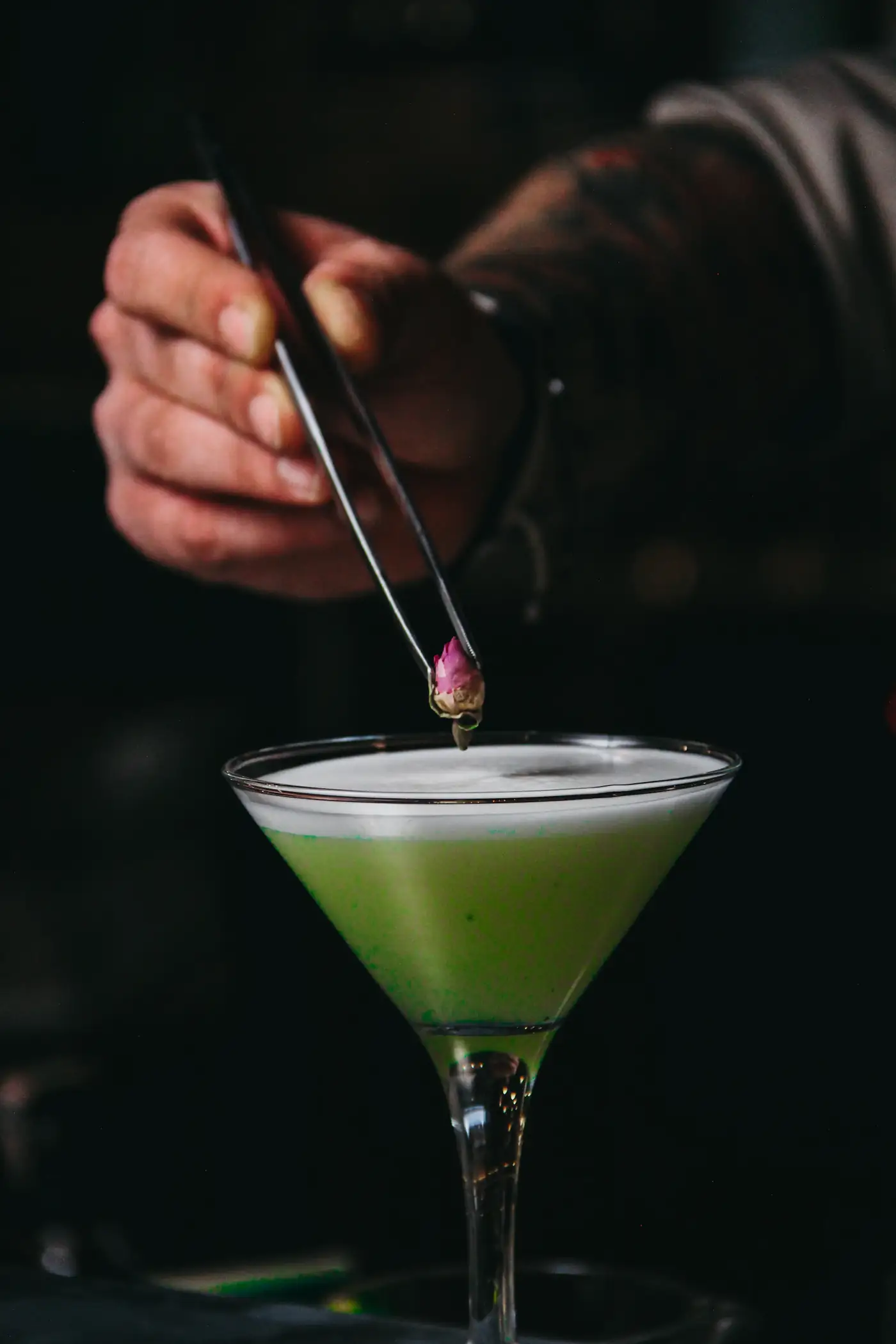 Bartender garnishing a martini